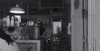A cozy cafe counter with packaging materials and cleaning products visible.