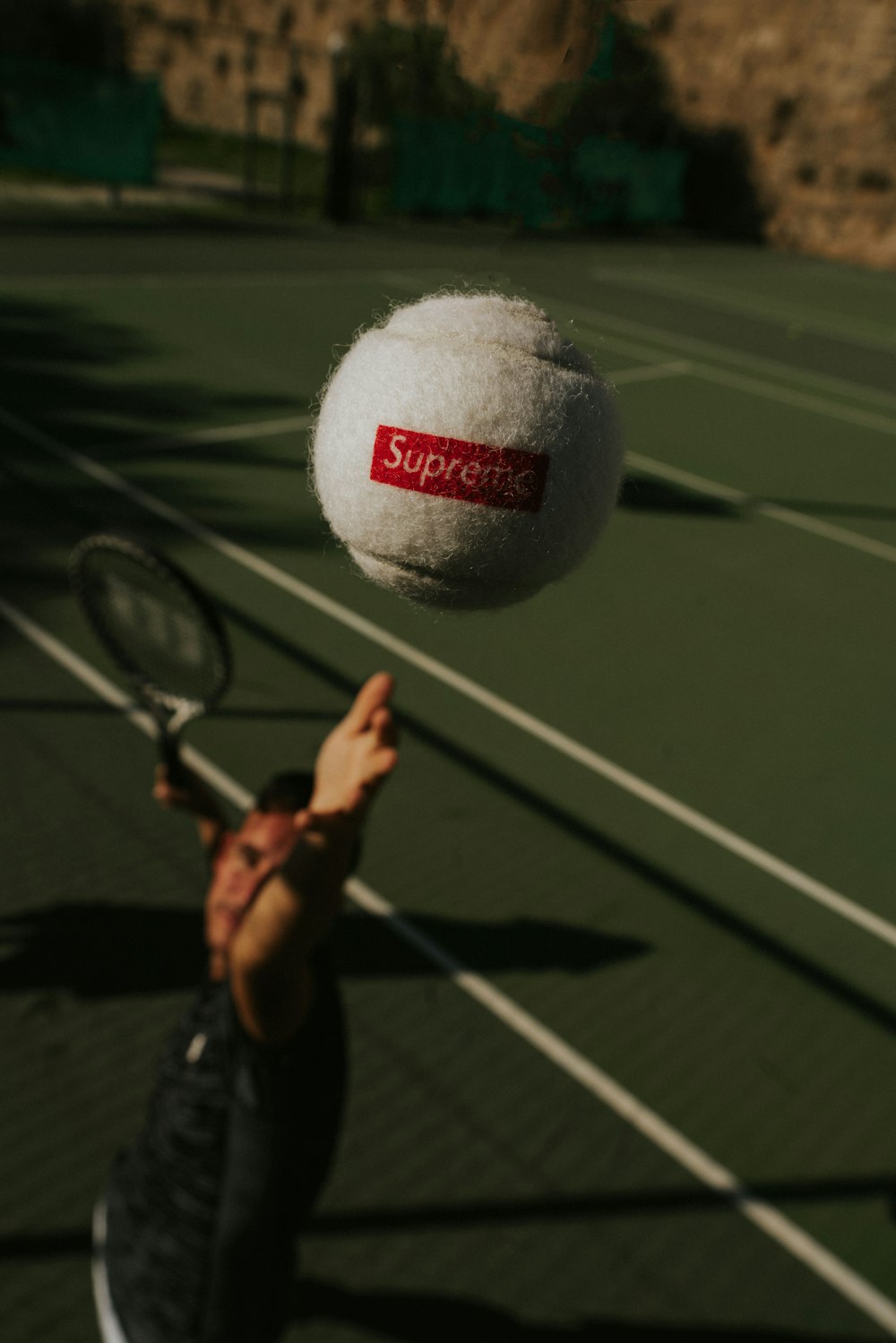 person holding white and red UNK tennis ball