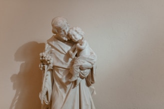 Elegant marble statue inspired by Swedish Grace, depicting a mother and child in a tender embrace.