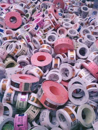 A vibrant close-up of colorful event tickets fanned out on a wooden table.