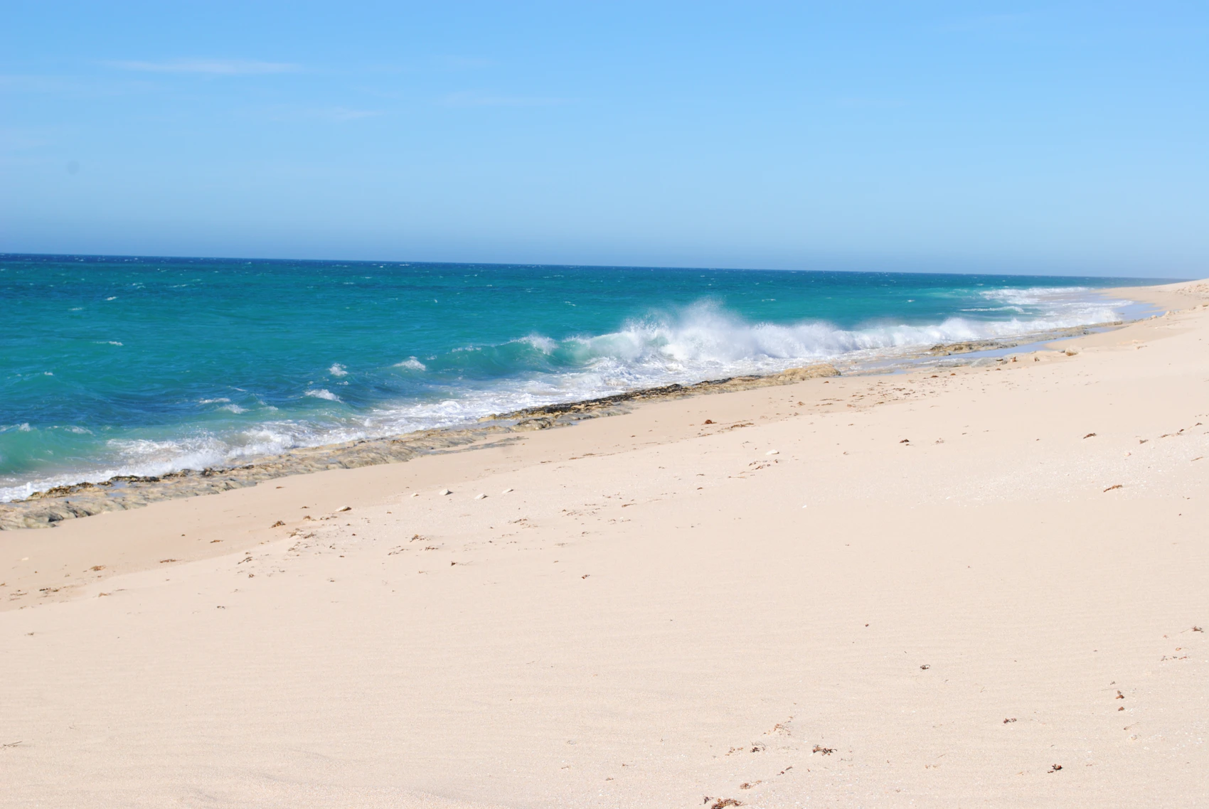 A pale sandy beach and clear blue water on Western Australia’s Ningaloo Coast