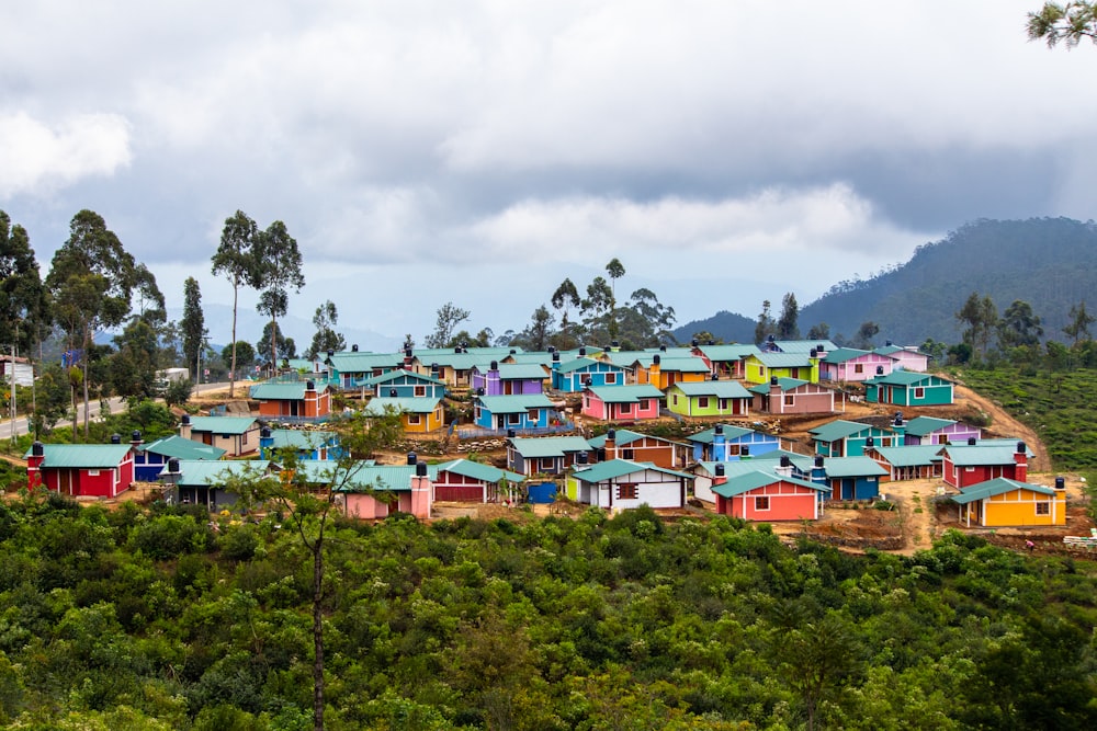 houses on green grass field under white clouds during daytime