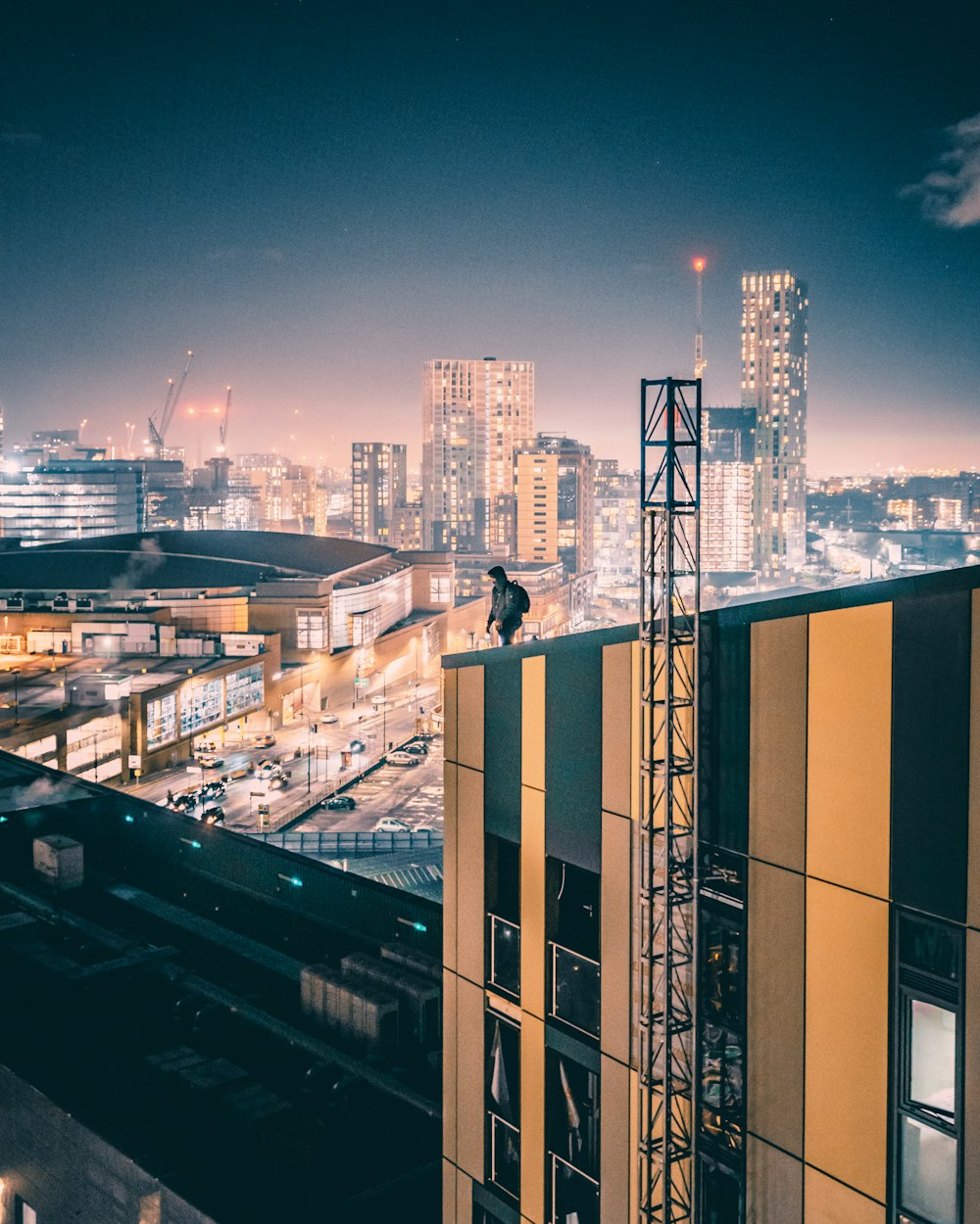 city buildings under blue sky during night time