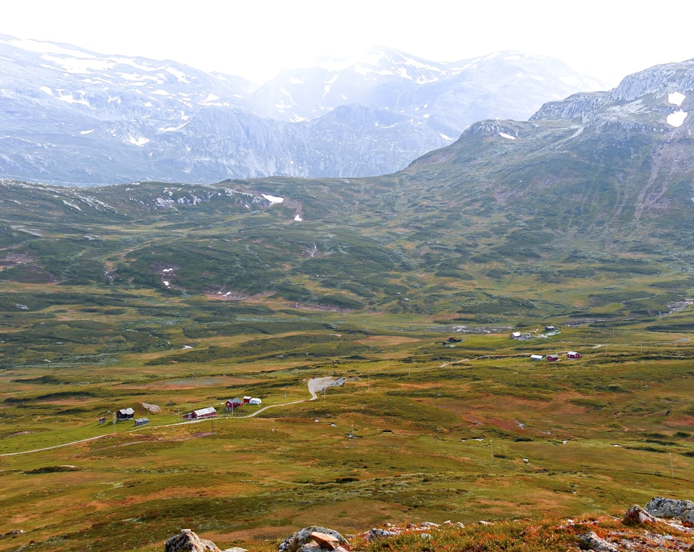 green grass field and mountains during daytime