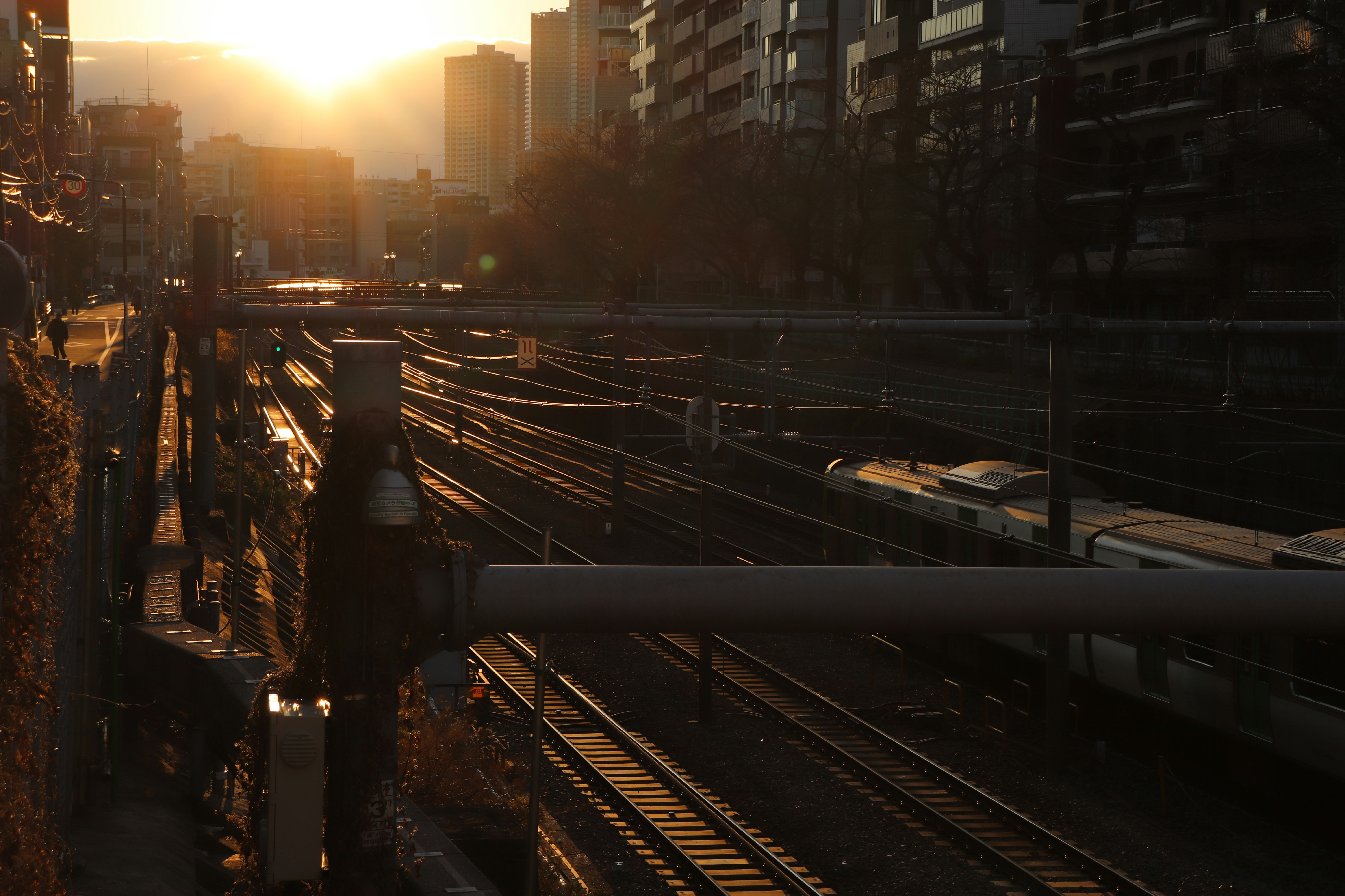 gray metal train rail near city buildings during daytime