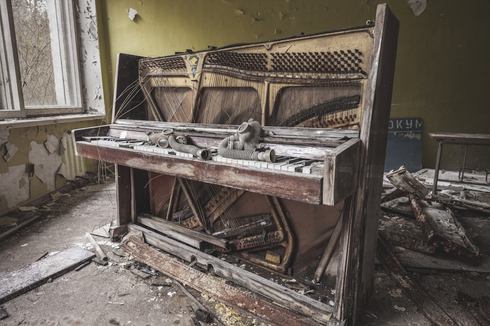 brown wooden piano near yellow painted wall
