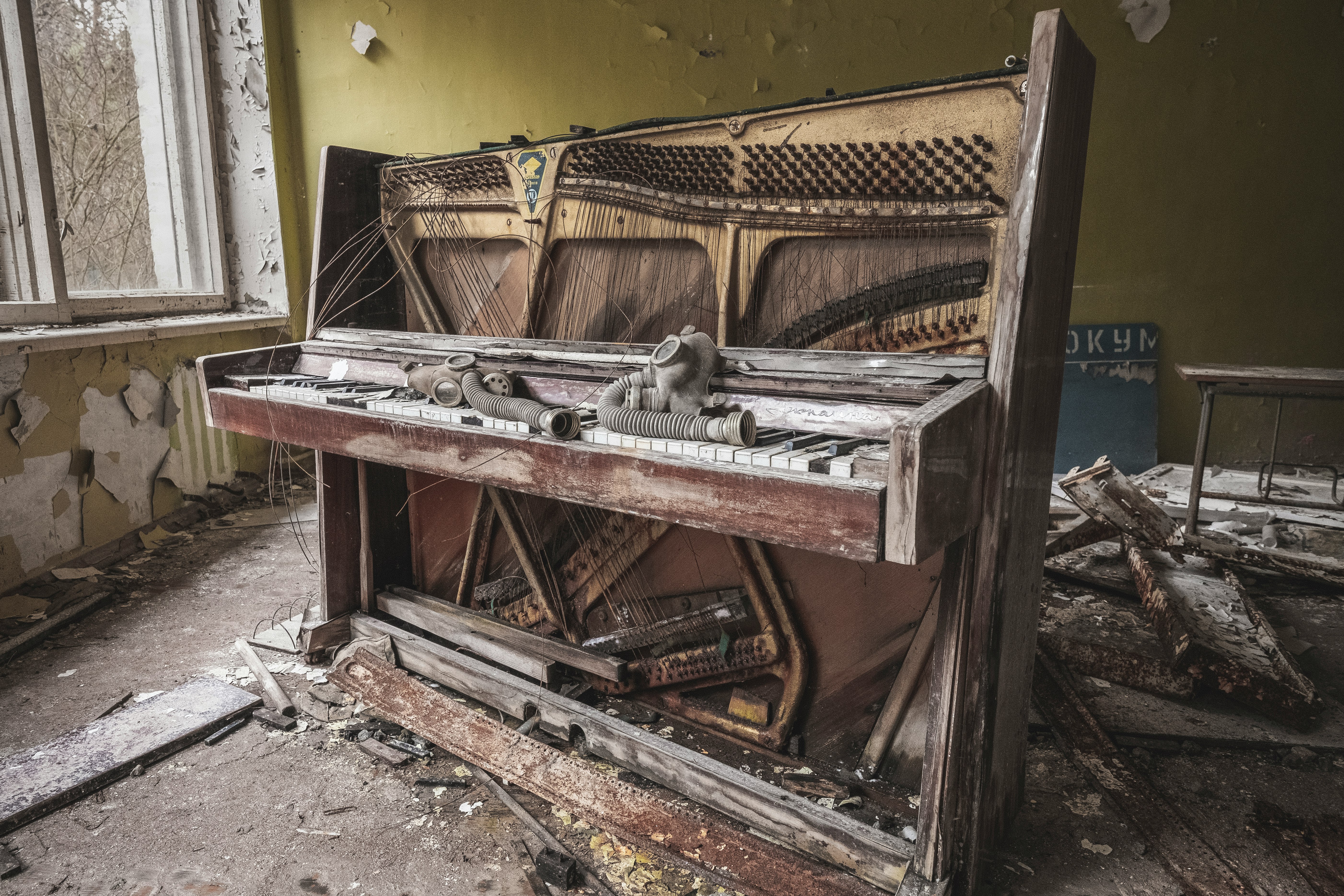 brown wooden piano near yellow painted wall