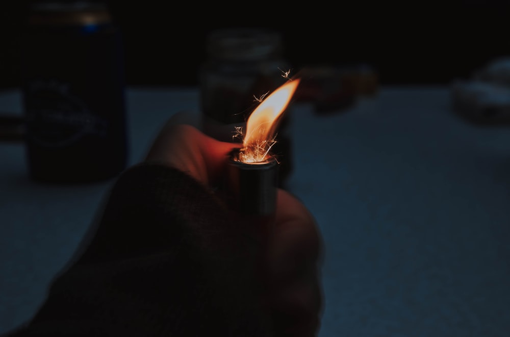 person holding lighter with fire