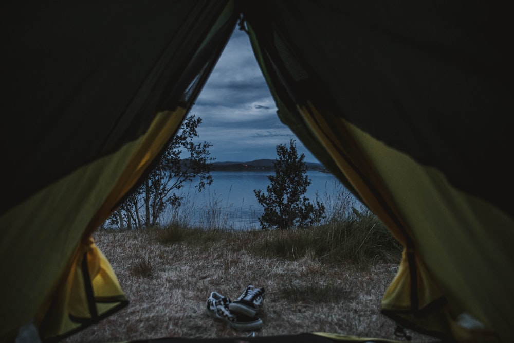 person in black shirt sitting inside tent during daytime