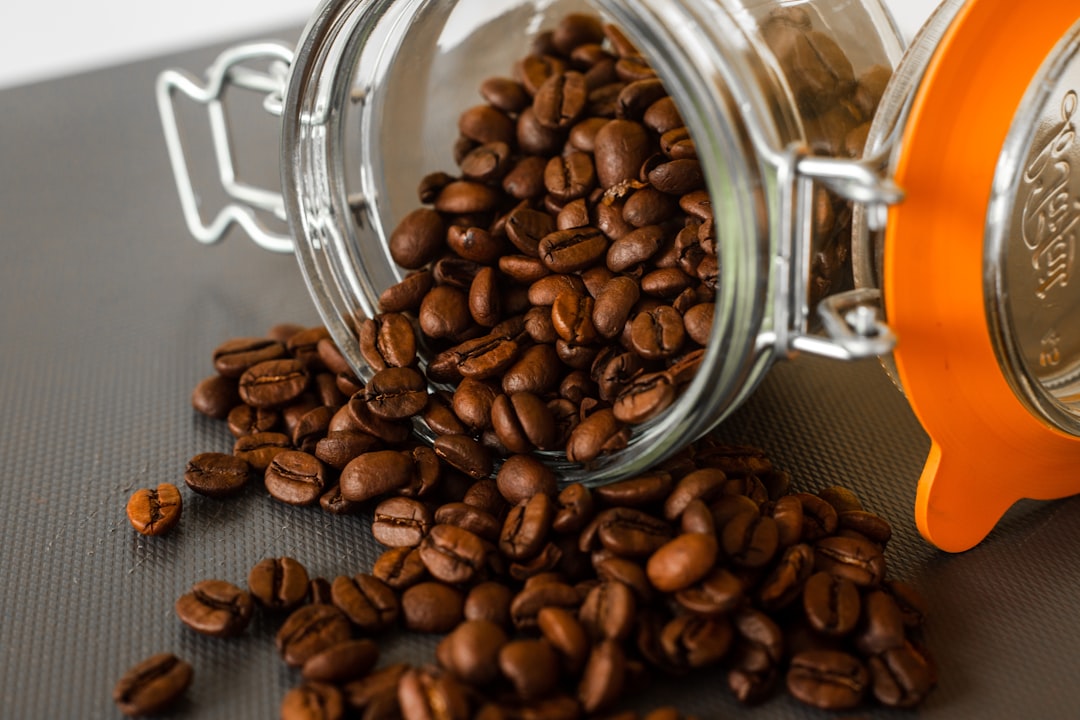brown coffee beans in clear glass jar