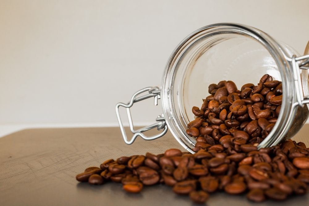 brown coffee beans in clear glass jar