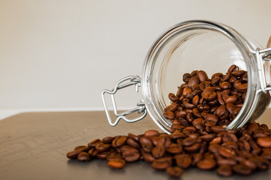 brown coffee beans in clear glass jar