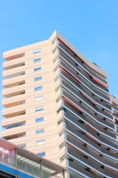 Modern luxury apartment building in South Jakarta with orange and light blue accents.