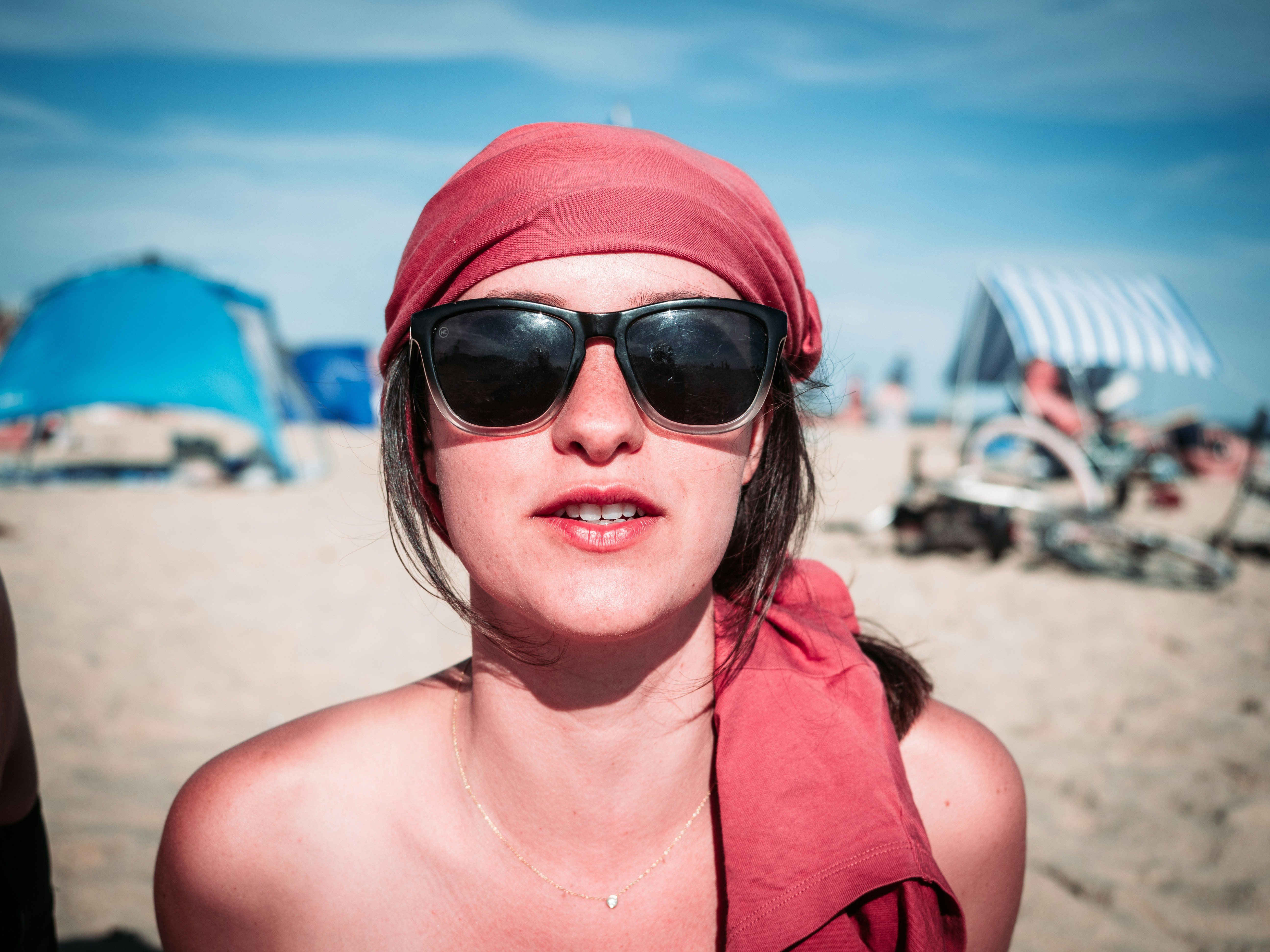 woman in red tank top wearing black sunglasses