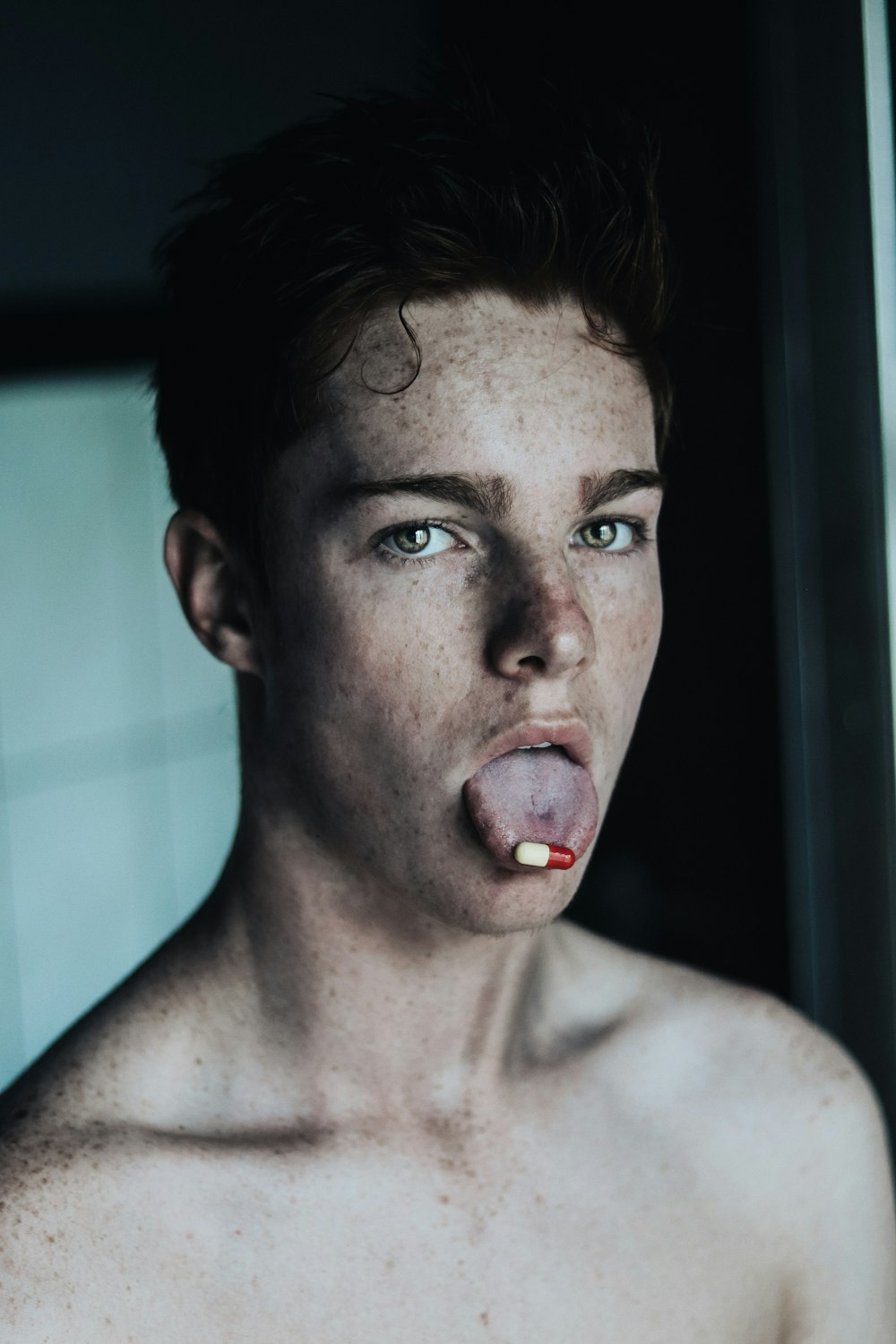 topless man with red tongue out