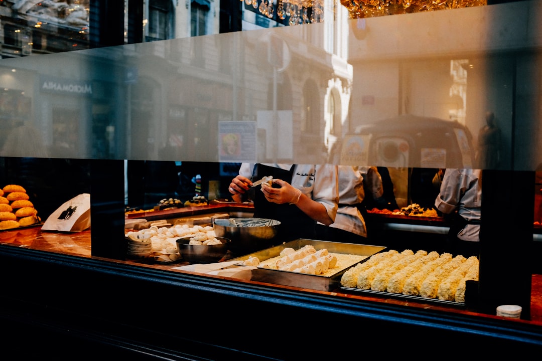 person in blue shirt standing in front of food display counter