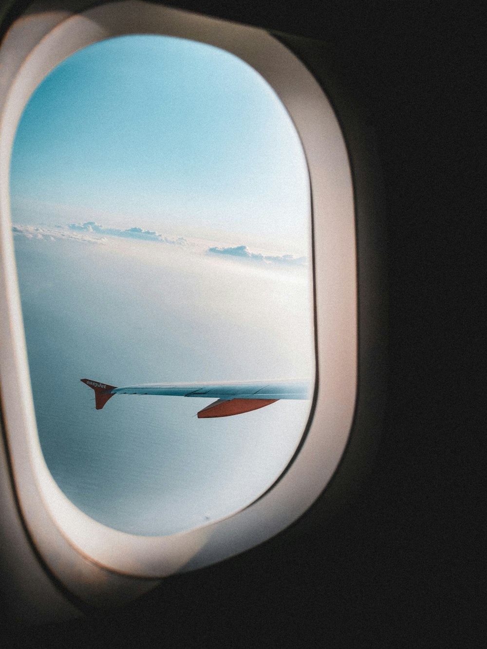 Vue du hublot de l’avion sur les nuages blancs pendant la journée