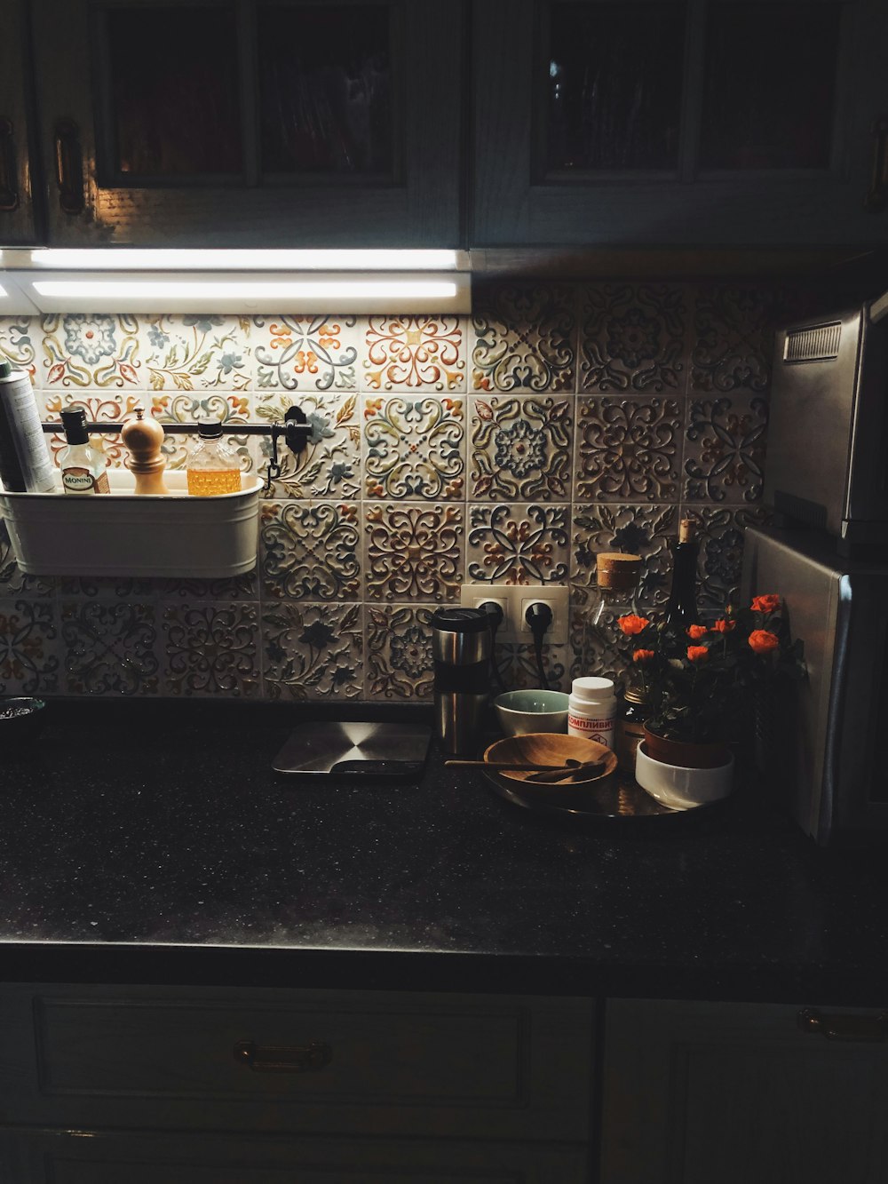 white ceramic bowl on black granite counter top