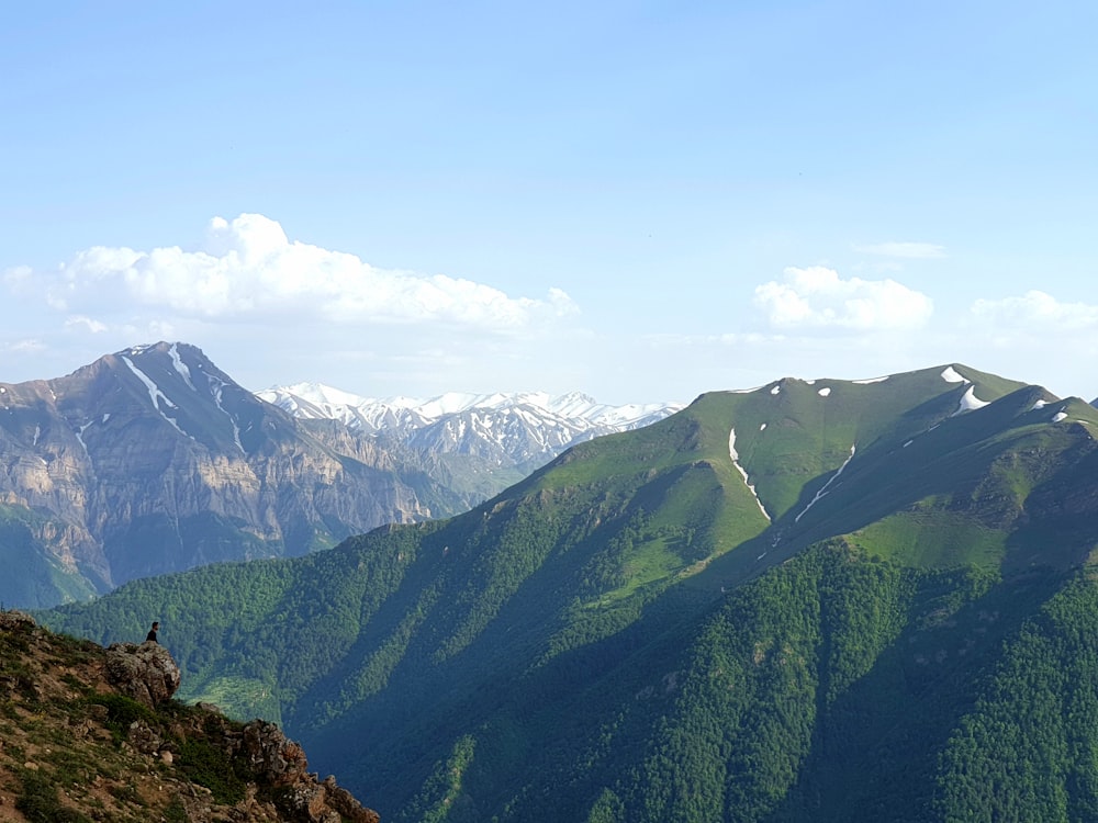 green mountains under white clouds during daytime