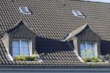 brown roof tiles near green plant during daytime