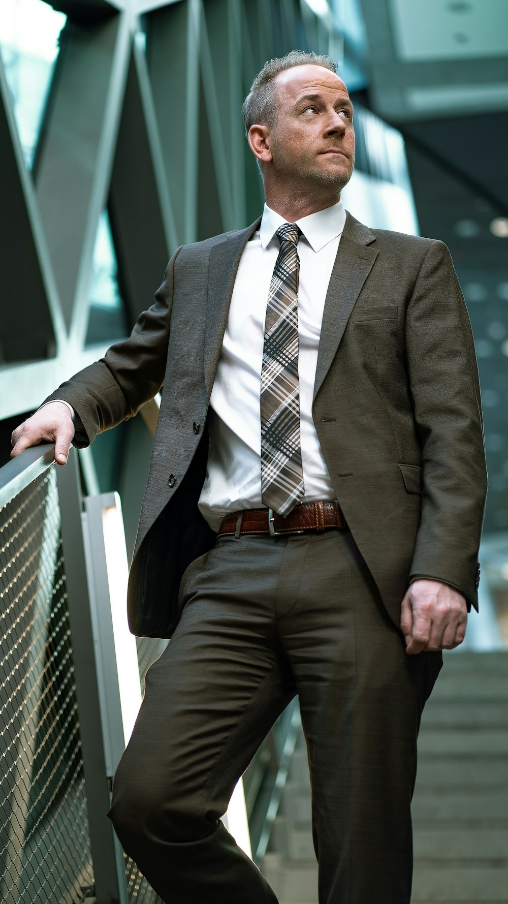 man in black suit sitting on white bench