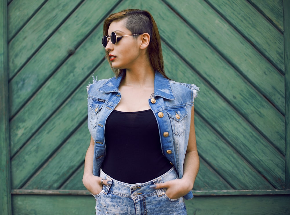 woman in blue denim jacket wearing black sunglasses