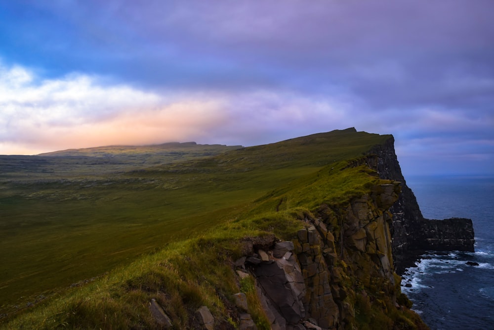 green grass field on mountain during daytime