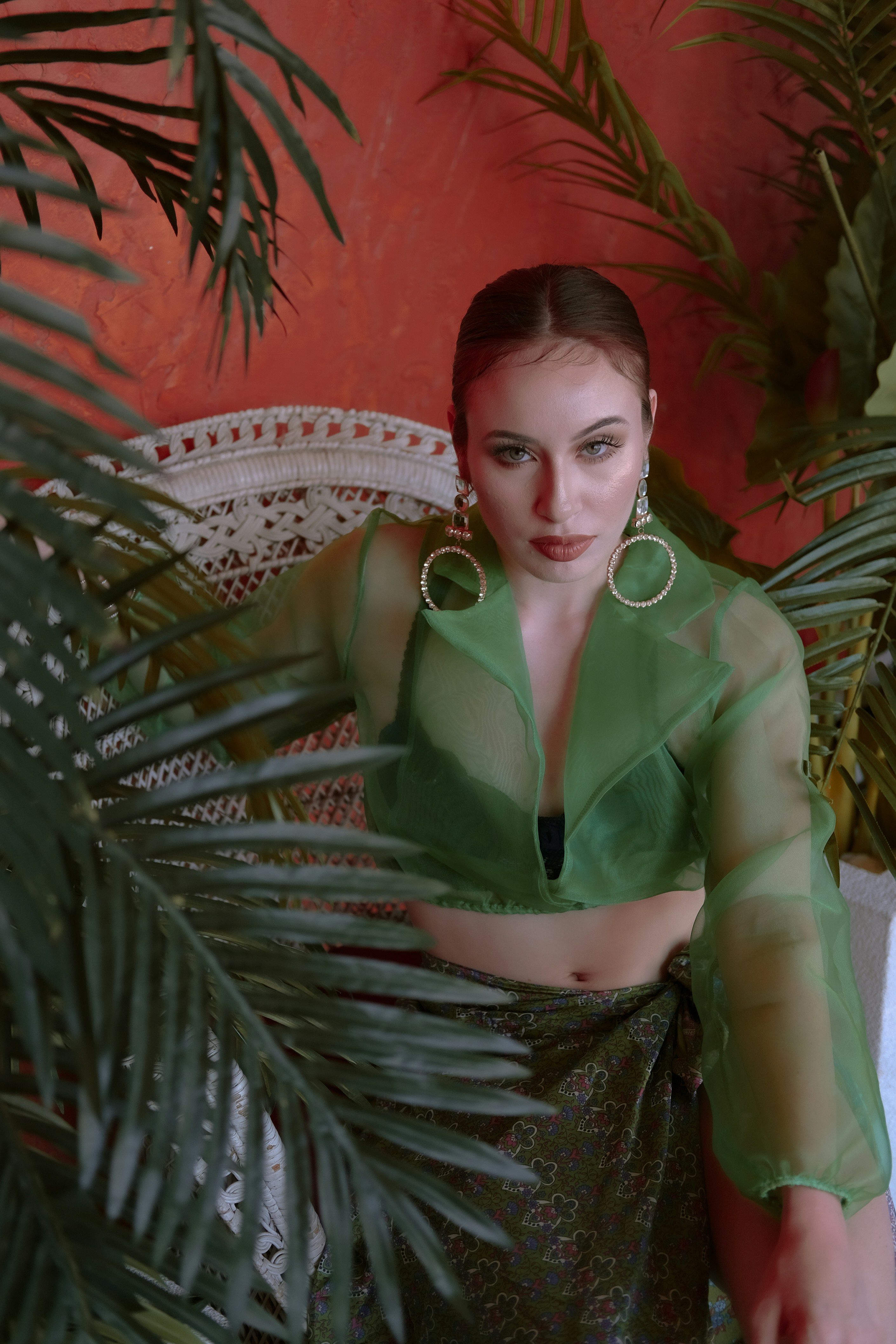 woman in green button up shirt sitting on chair