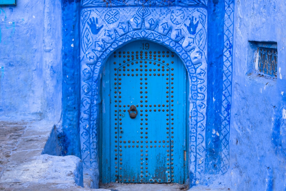 blue wooden door with blue steel door