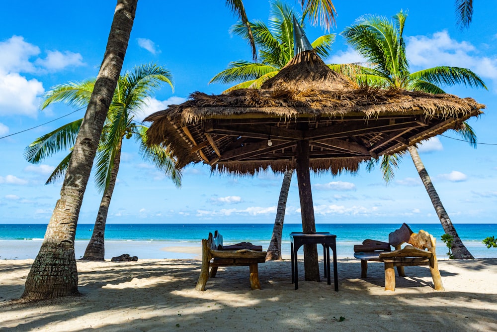 brown wooden beach lounge chairs on beach during daytime