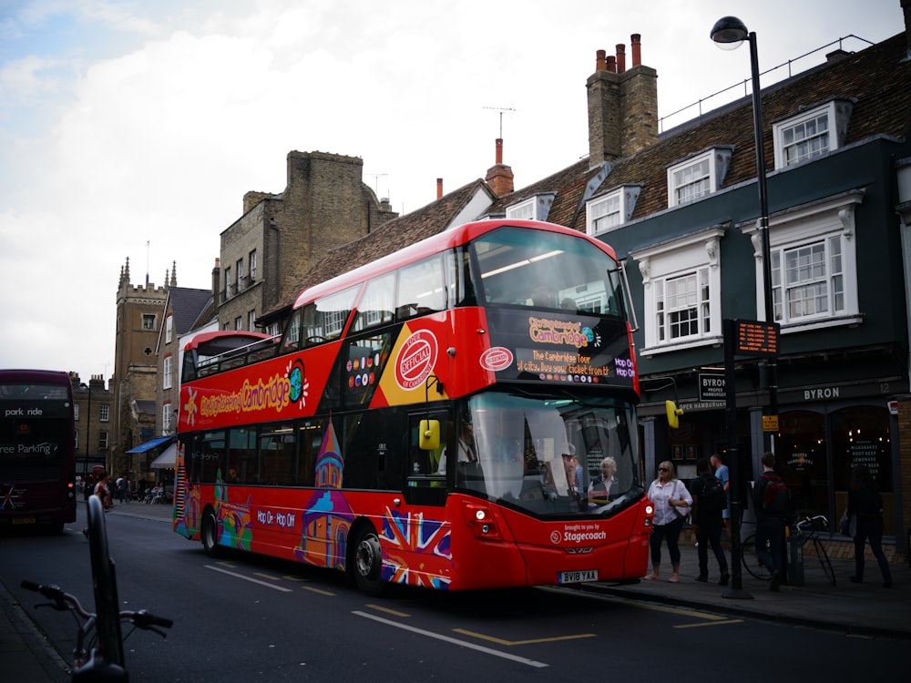 red double decker bus on road during daytime