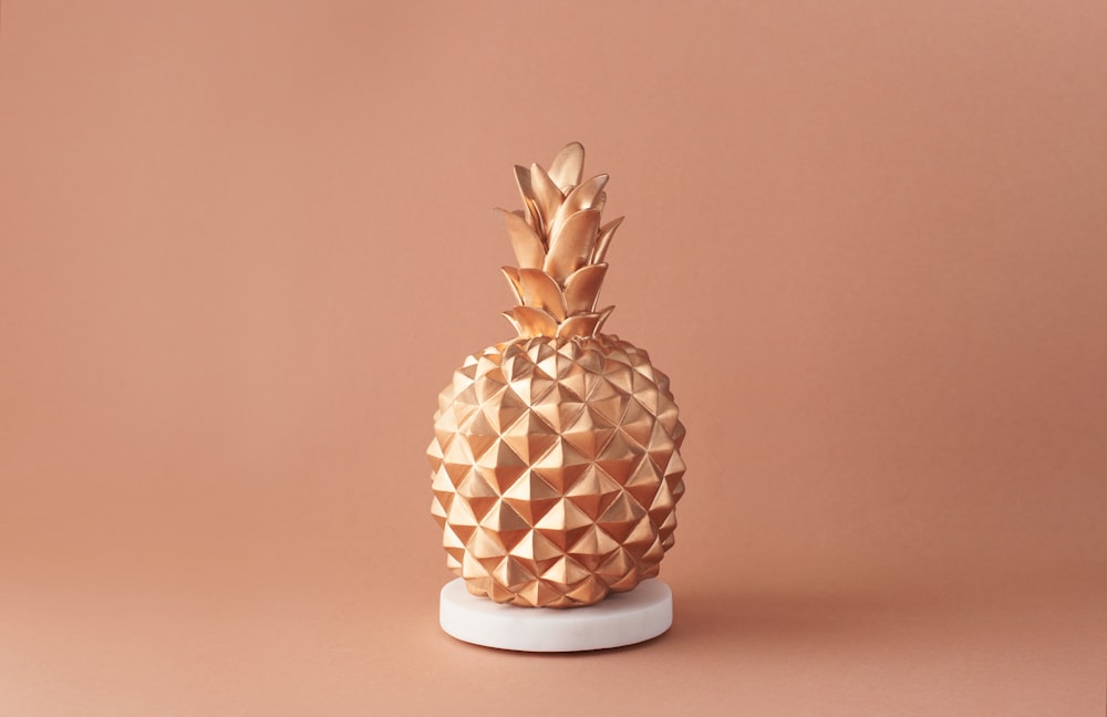 pineapple fruit on white and brown ceramic vase