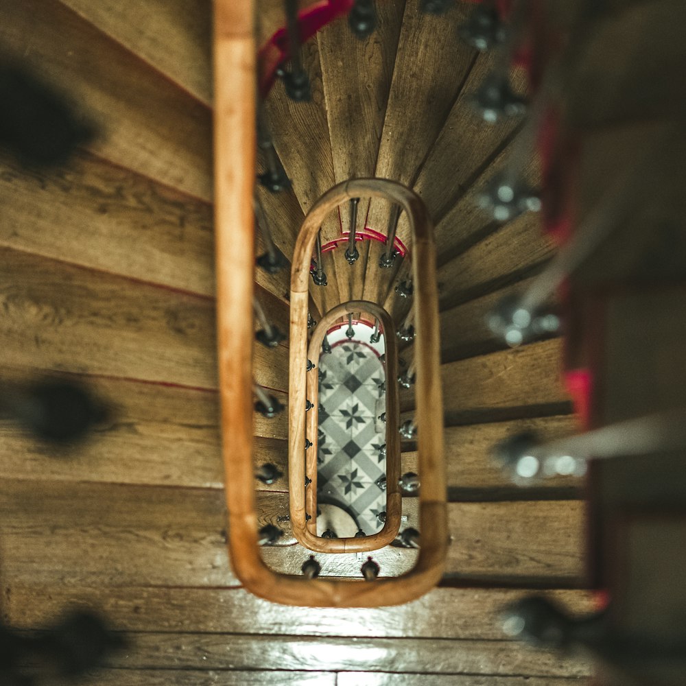 brown wooden spiral staircase with red and yellow metal railings