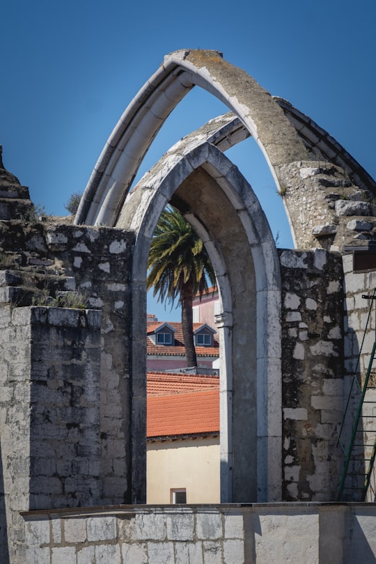 brown brick building under blue sky during daytime in Carmo Convent Portugal