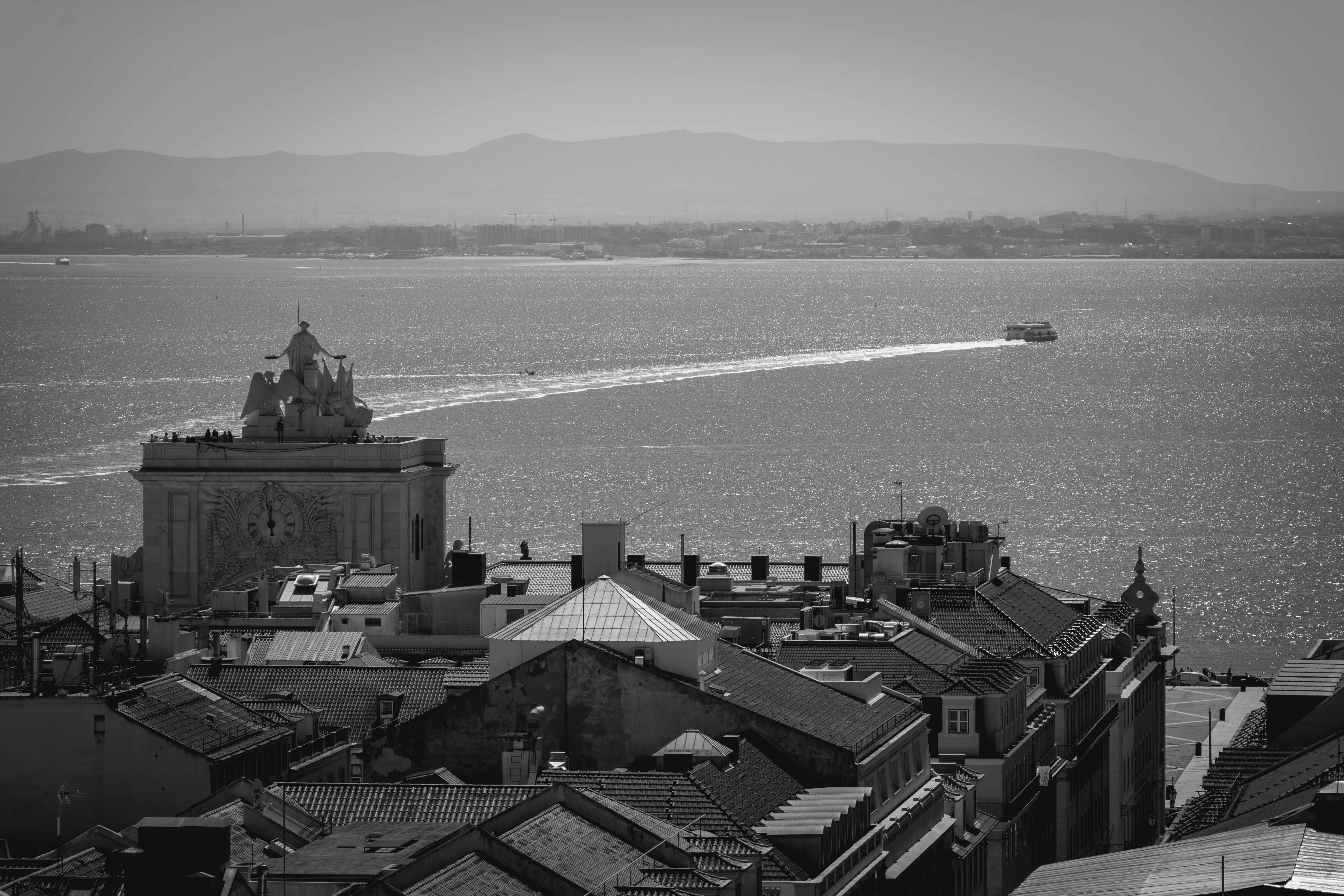 aerial view of city buildings near body of water during daytime