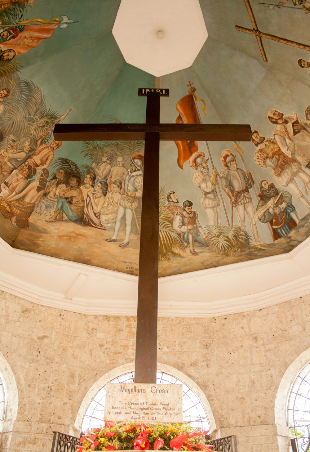 brown cross on white wall