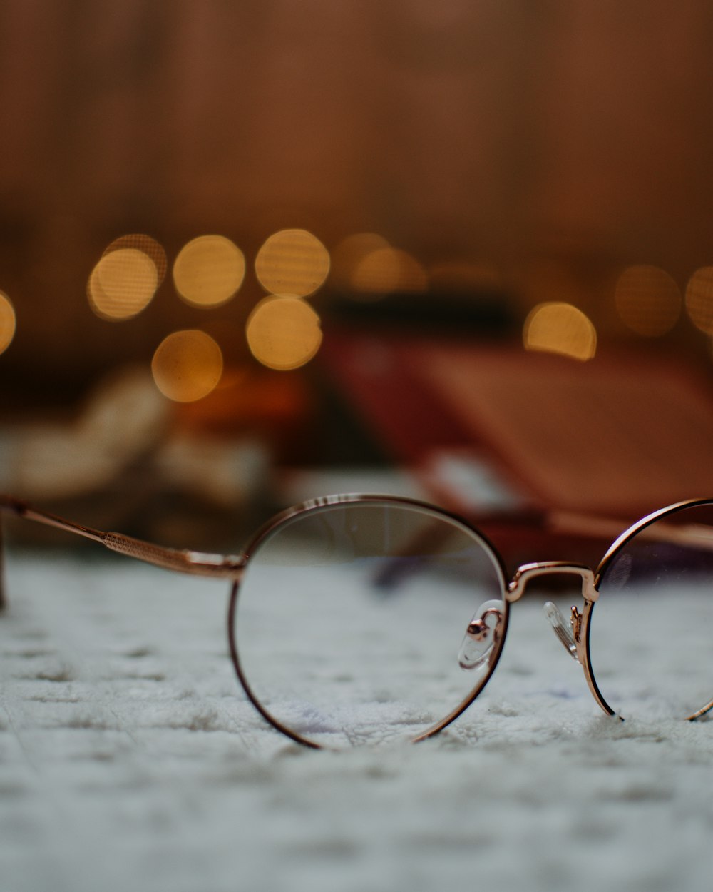 silver framed eyeglasses on white surface