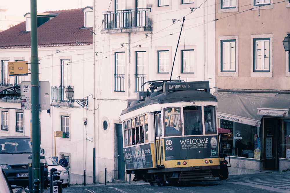 yellow and white tram on road during daytime