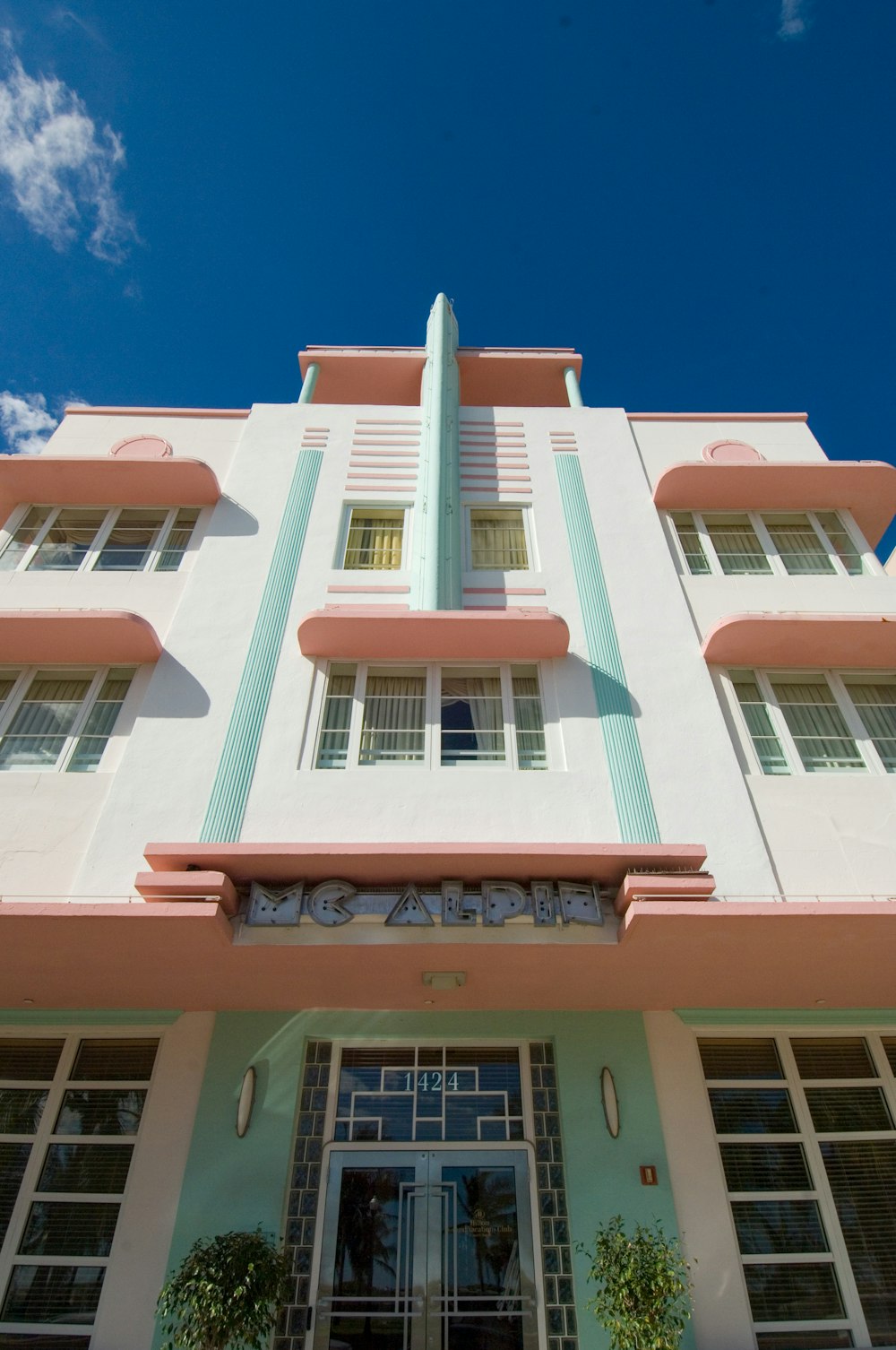 pink and white concrete building under blue sky during daytime
