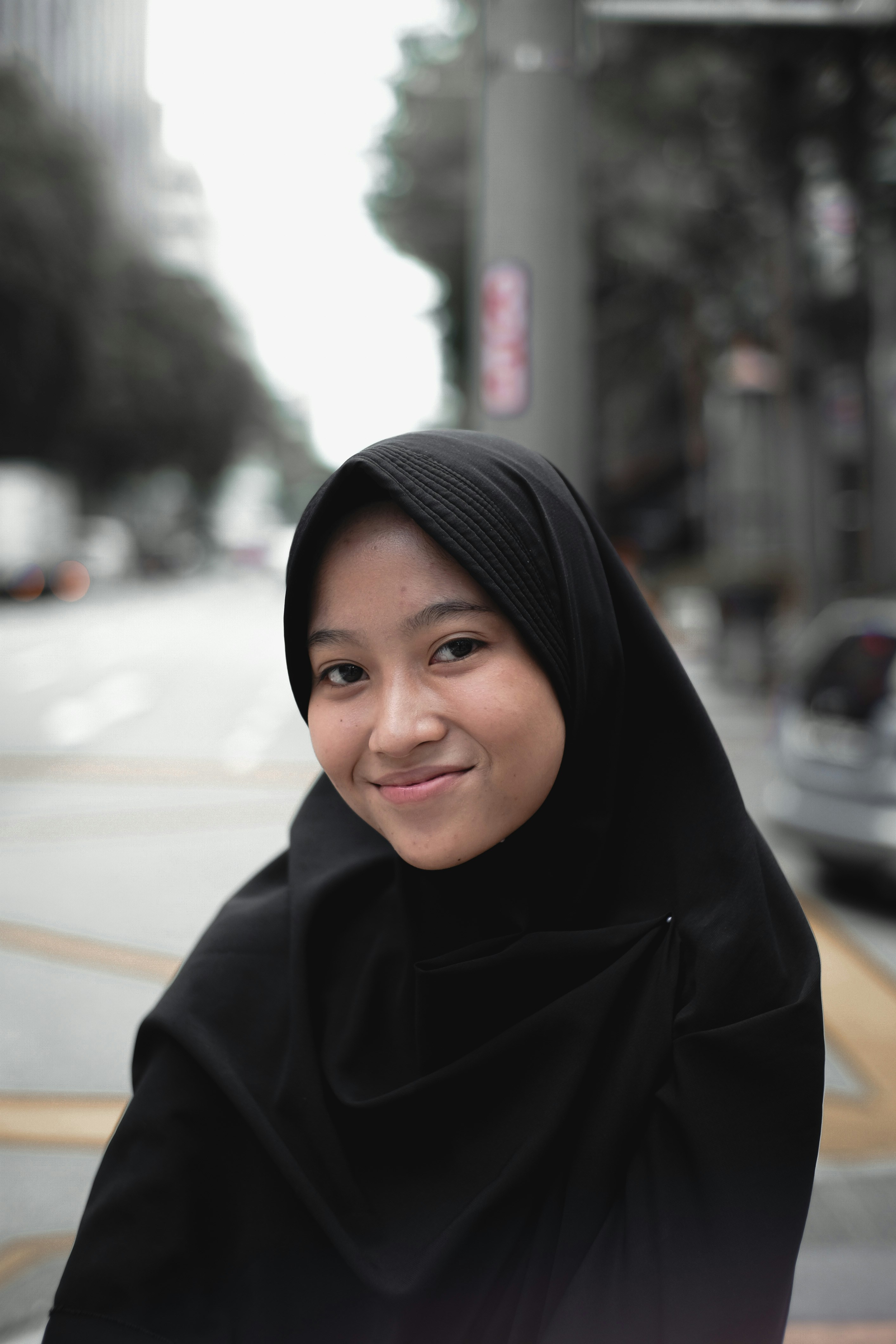 Fatima Al-Rashidi, a satisfied customer from Dubai wearing a hijab and smiling