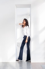 woman in white long sleeve shirt and blue pants