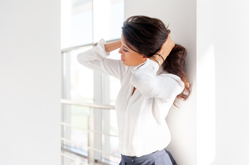 woman in white long sleeve shirt and blue denim jeans