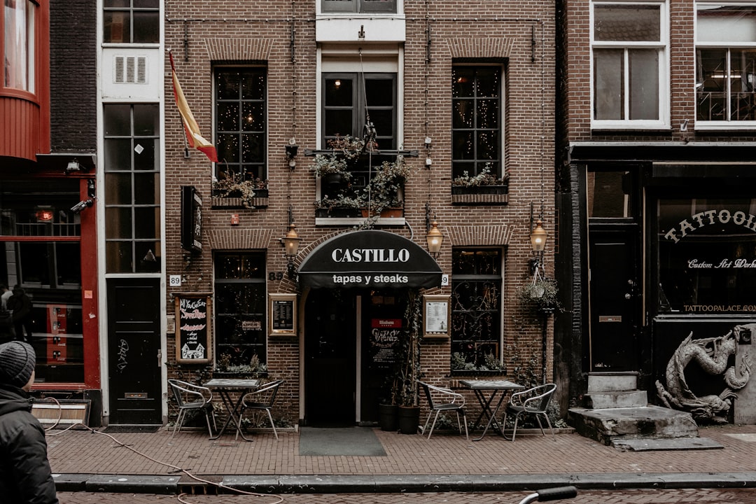 brown brick building with red and white signage