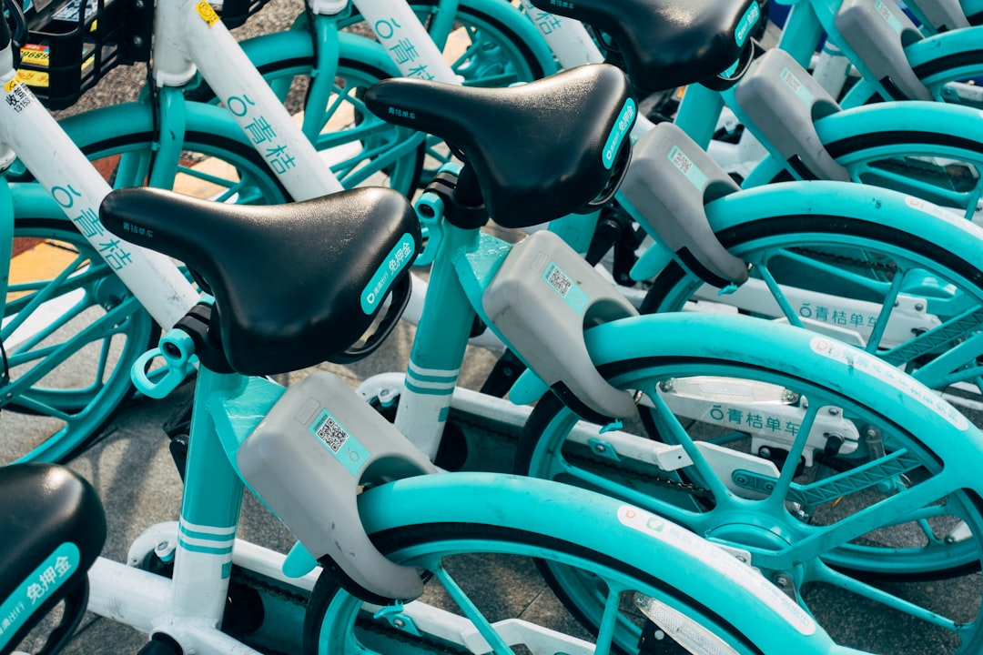 teal bicycle with white plastic bottles