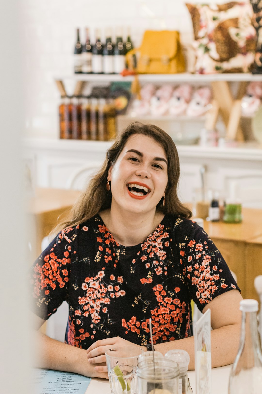 woman in black and red floral shirt smiling