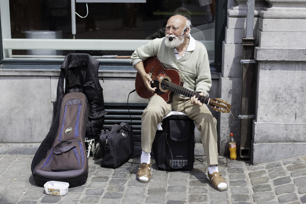 man in white dress shirt playing guitar