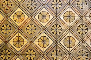 Patterned tile flooring featuring geometric designs in soft colors
