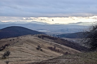 A scenic view of raw land in Colorado with rolling hills and open sky.