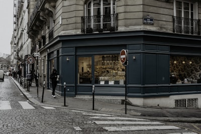 people walking on sidewalk near store during daytime