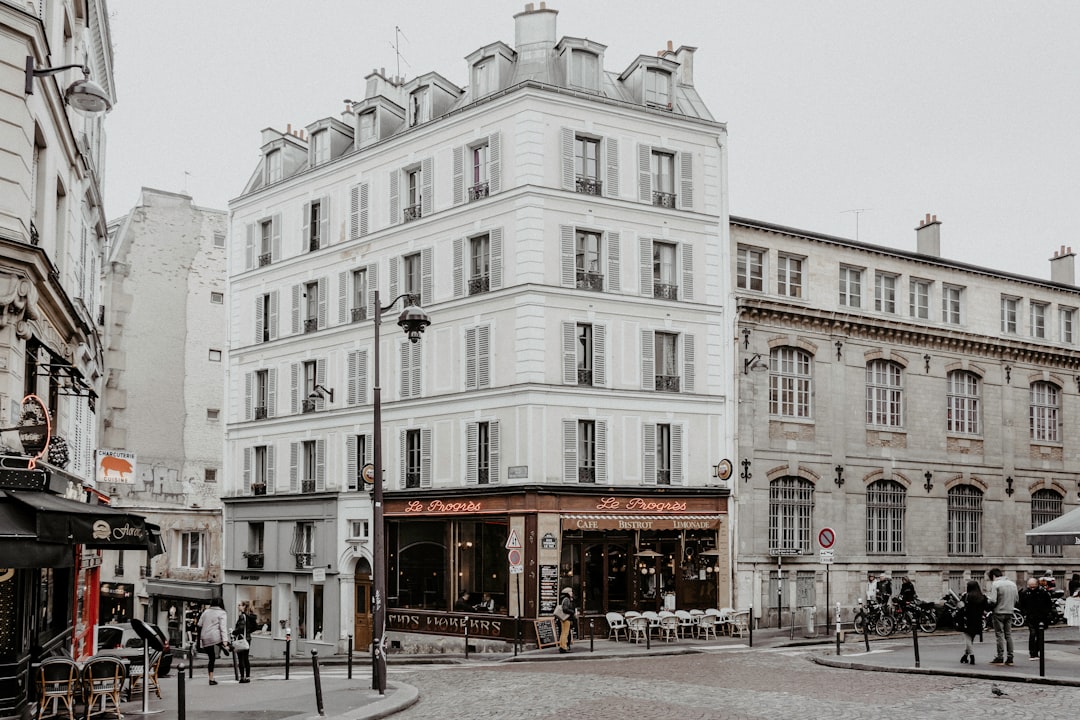 people walking on street near white concrete building during daytime